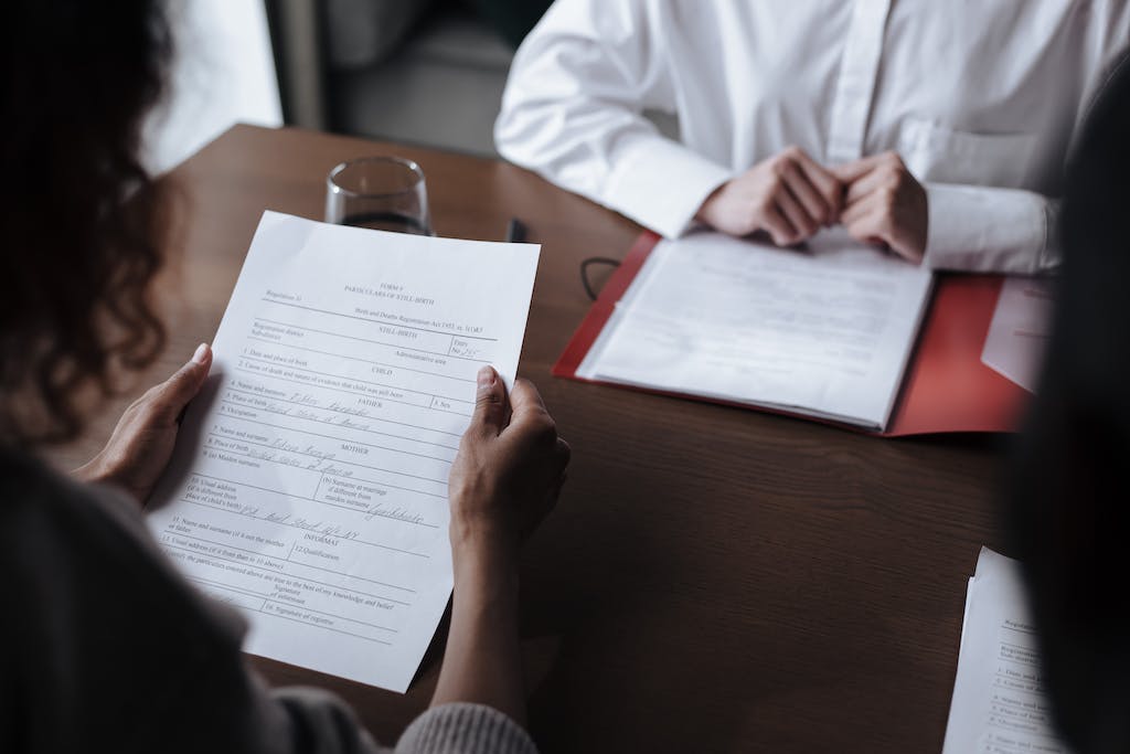 Unrecognizable Woman Reading Adoption Papers