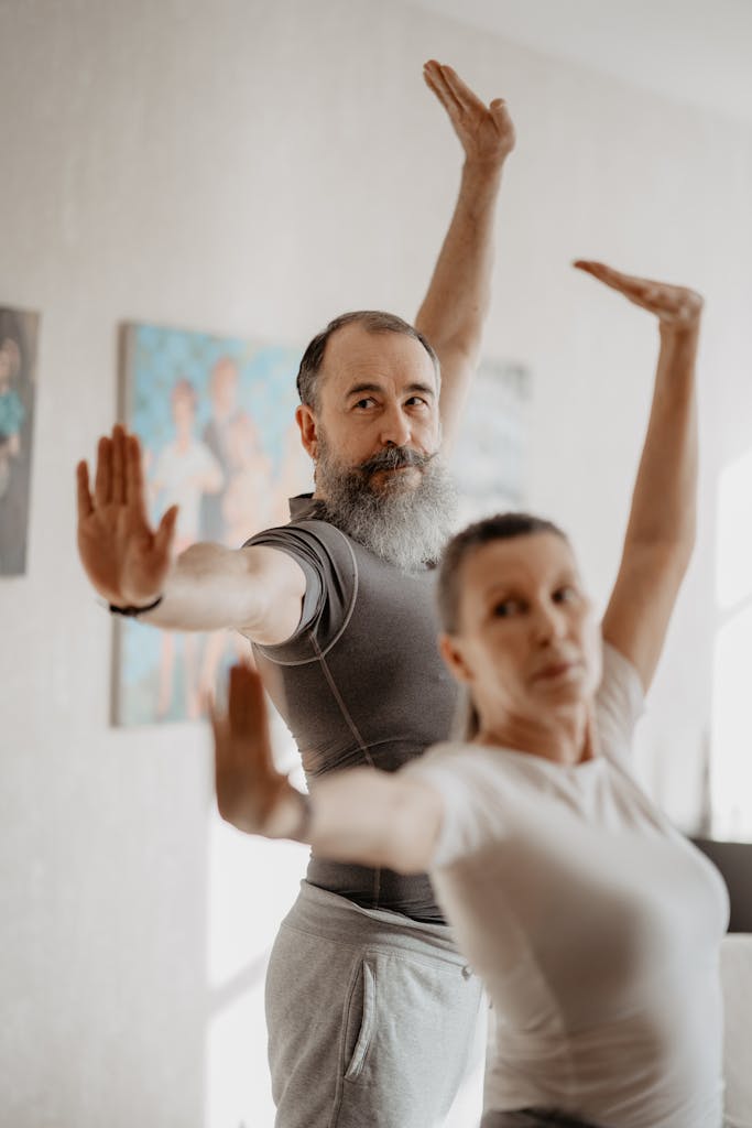 An Elderly Man and Woman Doing Yoga