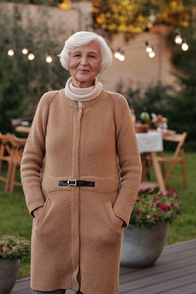 Elderly woman standing in garden