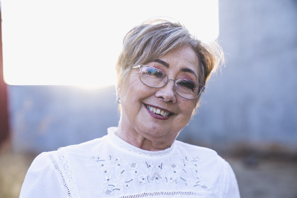 Portrait of Woman in White Top and Eyeglasses